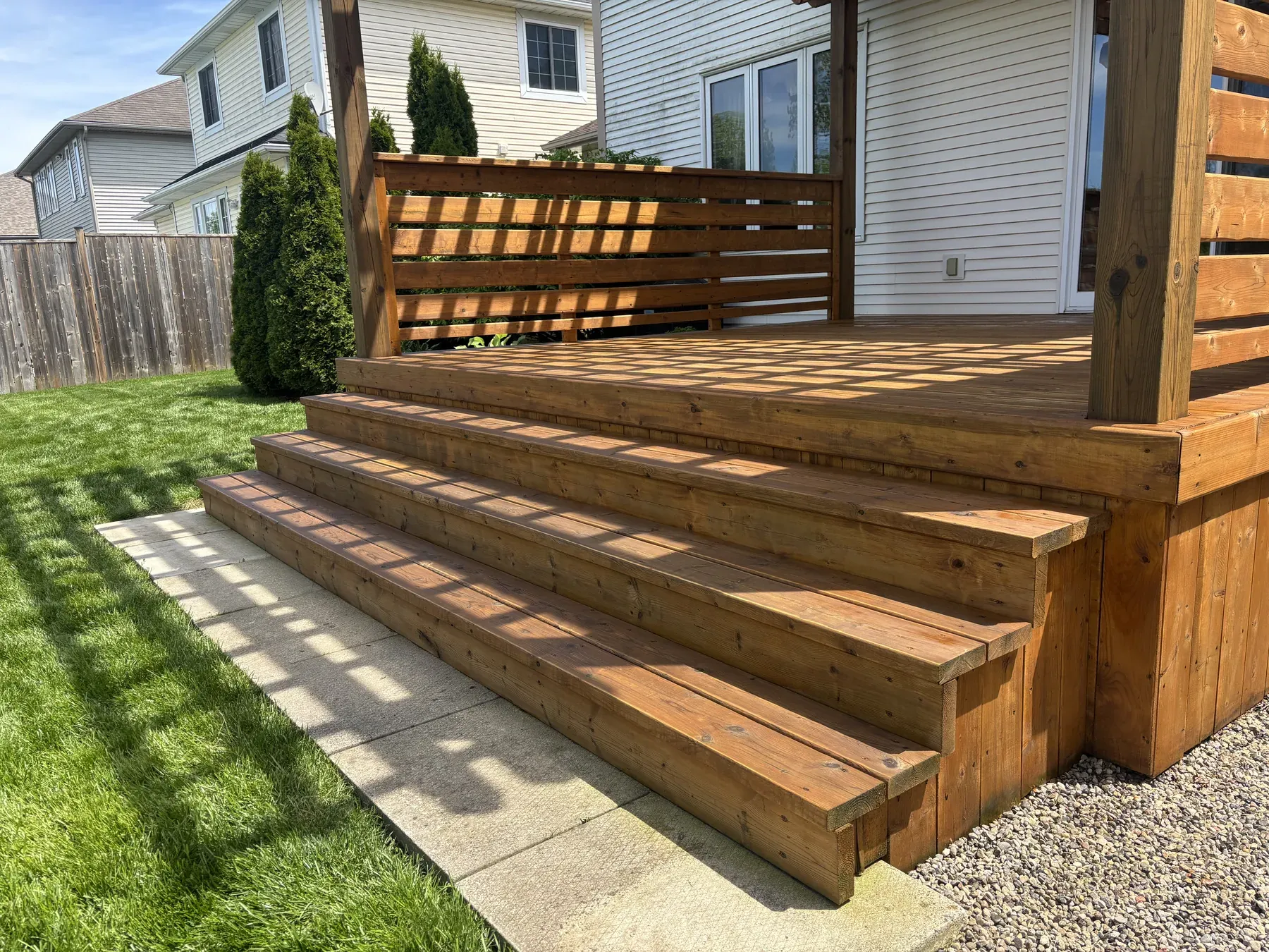 Niagara-on-the-Lake pergola — first stain applied to fresh wood
